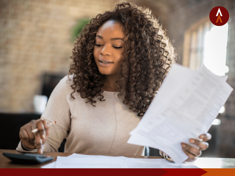 Woman looking at a calculator